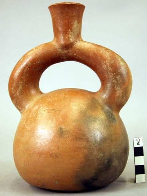 Ceramic bottle, stirrup spout, plain, mended, fire clouded exterior, rounded