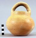 Plain buff pottery jar, median loop handle - unusual type