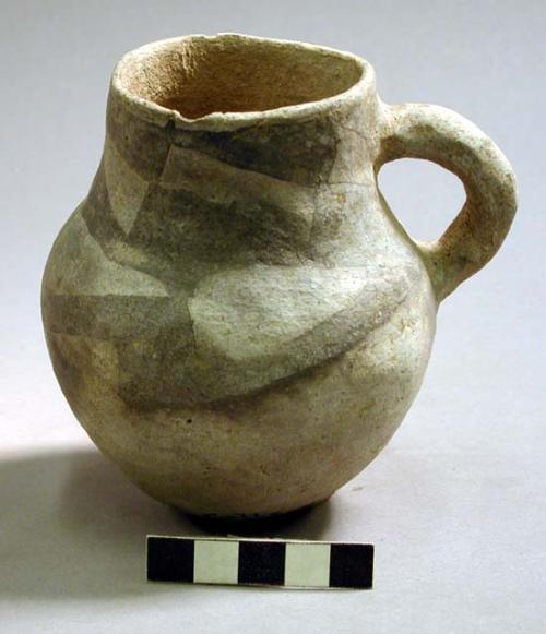 Black on white pottery jug