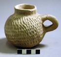 Tooled pottery handled jar