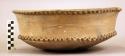Earthenware bowl with carved serrated rim and base