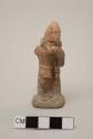 Figurine, molded, painted?, man with ocarina, conical hat, missing right arm; base not original