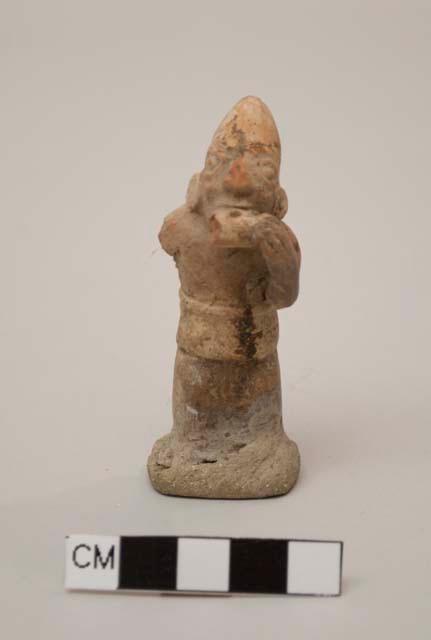 Figurine, molded, painted?, man with ocarina, conical hat, missing right arm; base not original