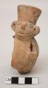 Miniature effigy jar, molded and painted man, perforated ears, incised face; repaired; pieces missing
