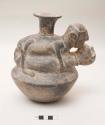 Effigy vessel, shouldered jar, copulating man and woman/animal?, narrow neck with flared rim