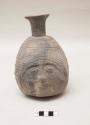 Effigy vessel, molded?, head with hat and hair; narrow neck with flared rim