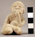 Seated clay figurine