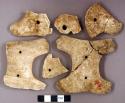 Ground stone gorget fragments, two perforated holes