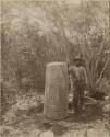 Man posing with hieroglyphic pillar