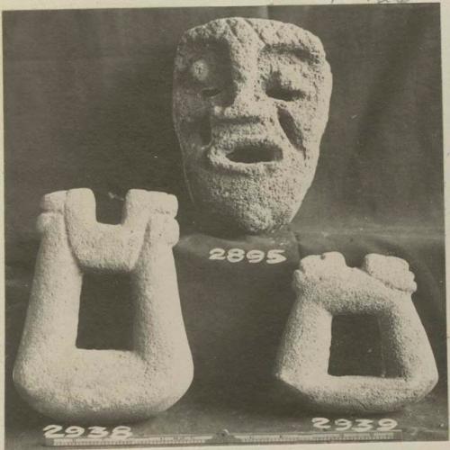 Carved stone mask and two carved stone objects