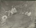 Two men seated with altar