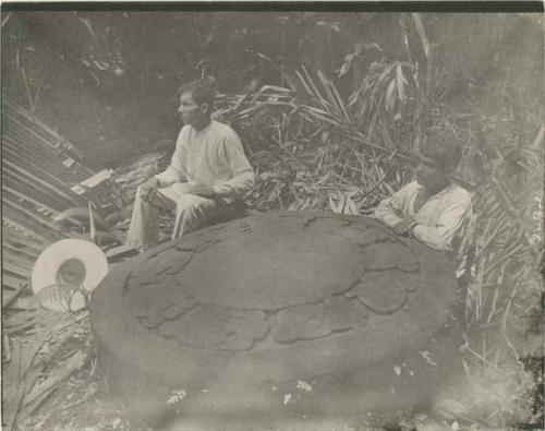 Two men seated with altar