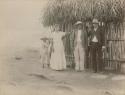 Child, woman and two men in front of hut ; Ladinos or "half-castes"