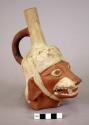 Ceramic bottle, stirrup spout, zoomorphic figure, molded face and ears