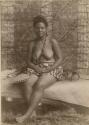 Samoan woman, seated, holding fan