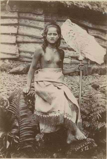 Samoan girl, posed holding taro leaf