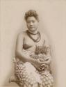 Samoan woman, posed, holding two pineapples