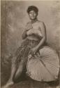 Samoan woman, posed with large fan