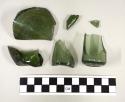 Green bottle glass sherds, including complete base and portion of flask or vial,