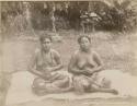 Two Samoan women seated outside on cloth