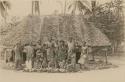 Group photo, Samoans posed in front of hut