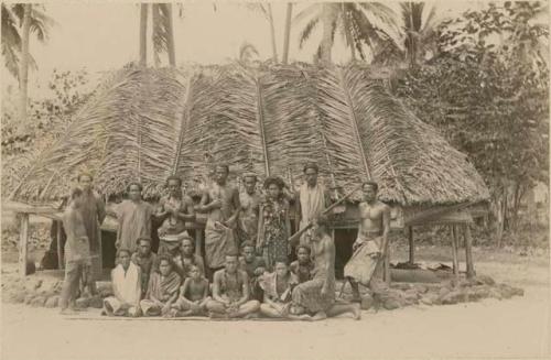 Group photo, Samoans posed in front of hut
