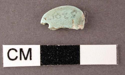 Fragment of turquoise pendant, single perforation at end - 1.1 x .6 x .2 cm.