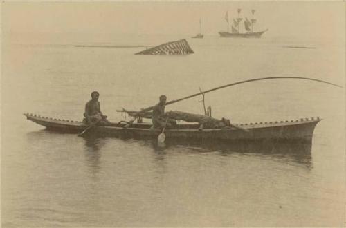 Two men paddling canoe