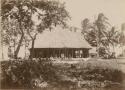 People seated outside the fale tele, or meeting house