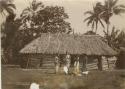 Samoan women, posed outside of long house