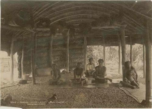 People seated inside long house