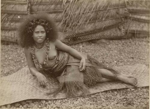 Samoan girl, posed, lounging on mat