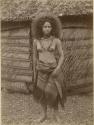 Samoan woman, posed in front of house