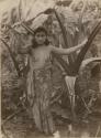 Samoan woman posed holding a leaf for cover