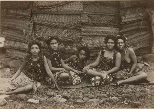 Young Samoan women posed in front of house