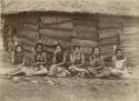 Six young Samoan women pose in front of house