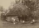 Family outside of round house, or fale tele