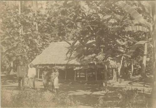 Police man, three women and another man stand outside police station