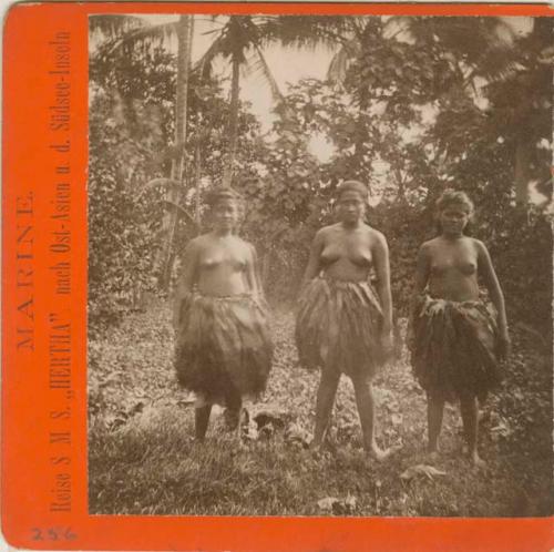 Three young women wearing grass skirts