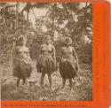 Three young women wearing grass skirts
