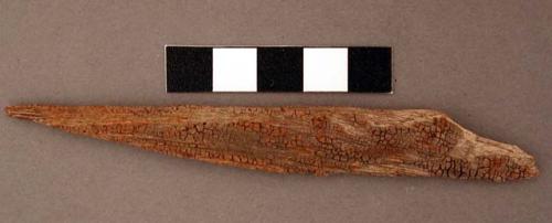 Piece of ironwood, with sharpened point. l: 11.6 cm.