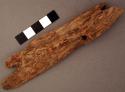Piece of ironwood, 1 notch at both ends. l: 14.5 cm.