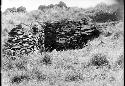 Stone house, with carved rocks in background