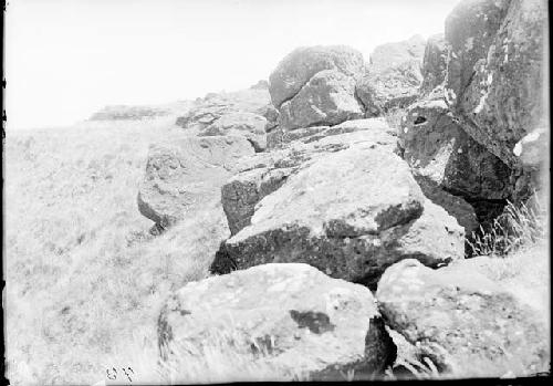 Carved stones, with stone house in background