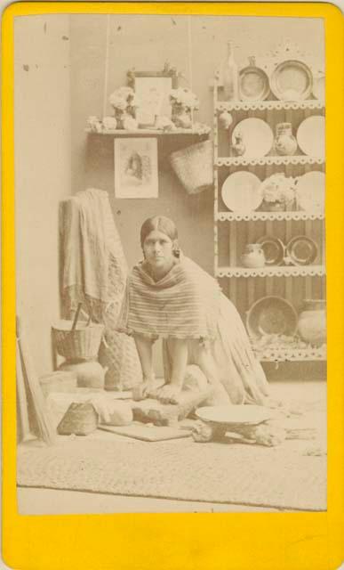 Portrait of woman grinding corn