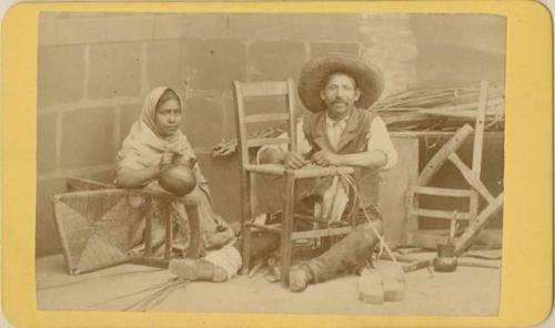 Portrait of man and woman mending chairs