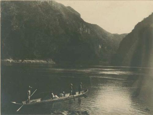 Mahongany Camps -- men rowing canoe down river