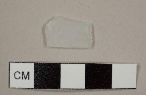 Colorless flat glass fragment, possibly frosted