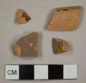 Lead-glazed redware sherds, including one rim to a possible bowl