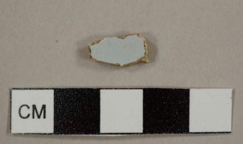 Tin-glazed buff earthenware sherd with pale blue glaze